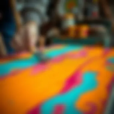 An artist applying a vibrant color paint to a wooden table.
