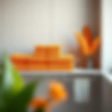 Vibrant orange towels elegantly arranged on a modern bathroom shelf